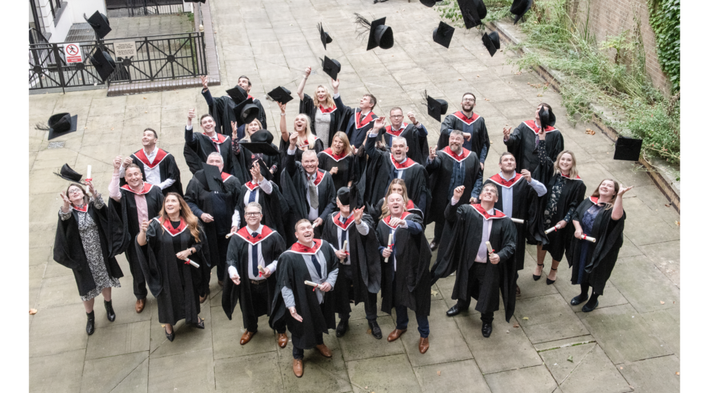 Graduates celebrating in academic gowns